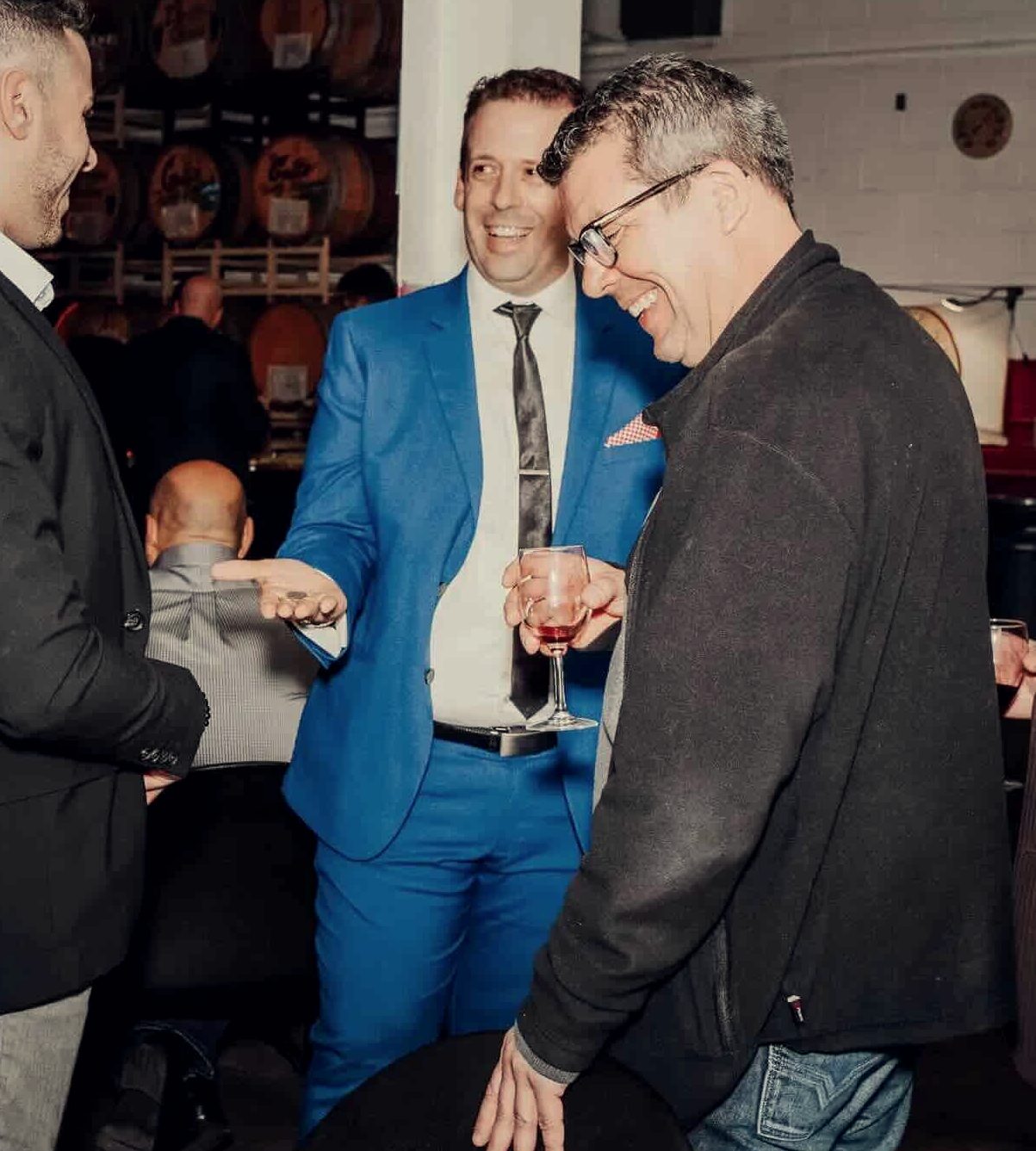 Guests connecting and laughing together at a corporate networking event