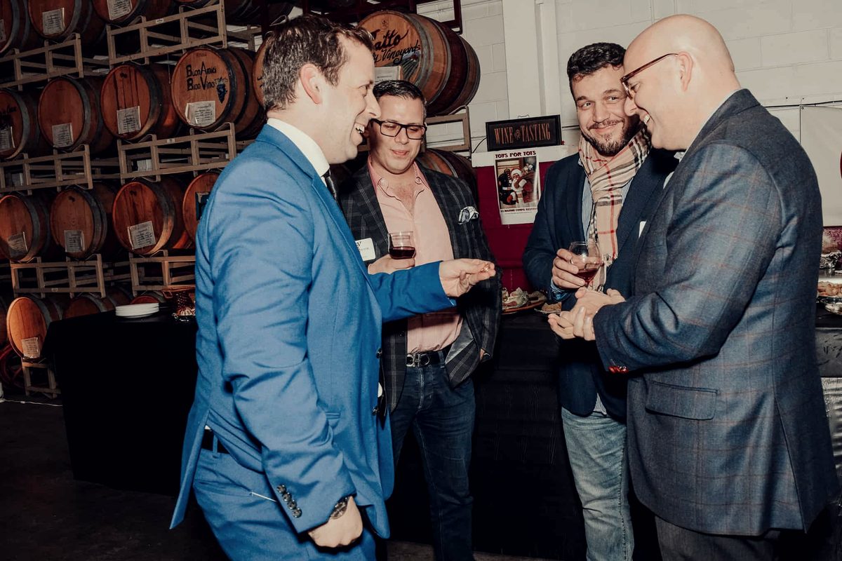 Eric Lerner performing close-up magic for a small group of guests at a corporate reception